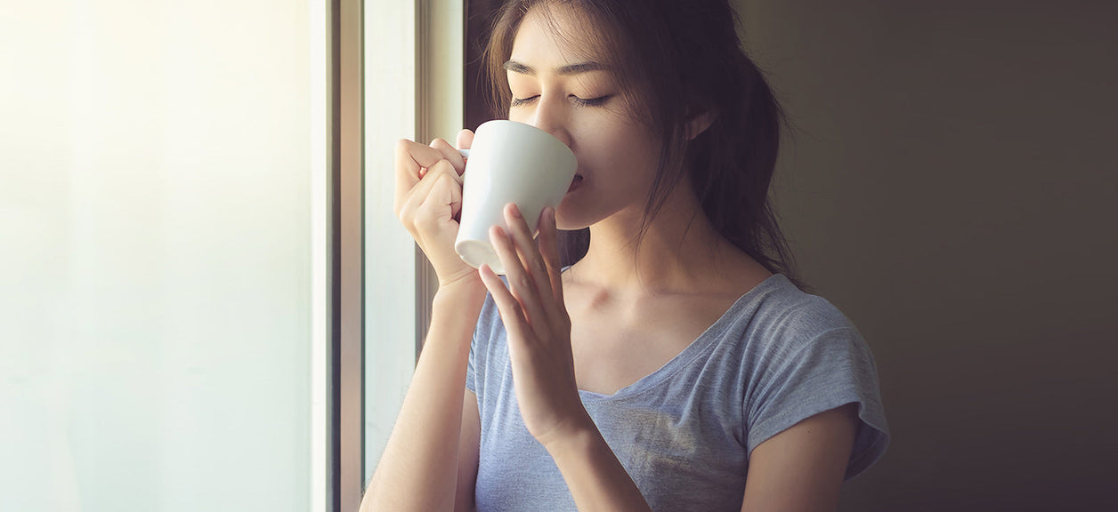 woman drinking from a mug