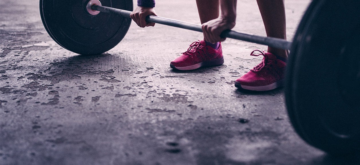 person holding barbell with weights