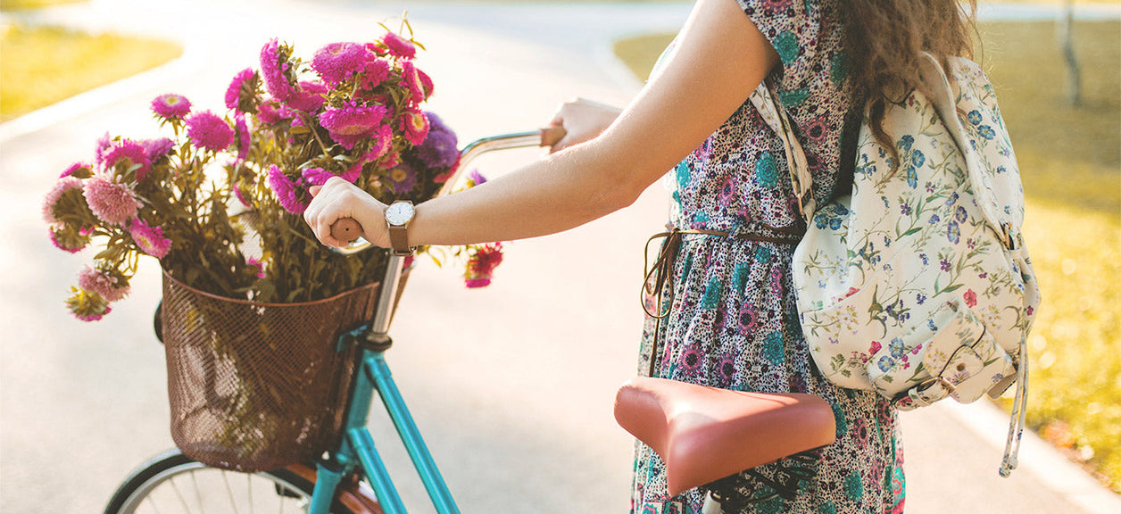 woman on bike carrying flowers