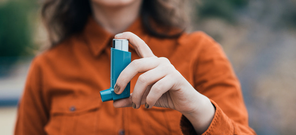 woman holding an inhaler
