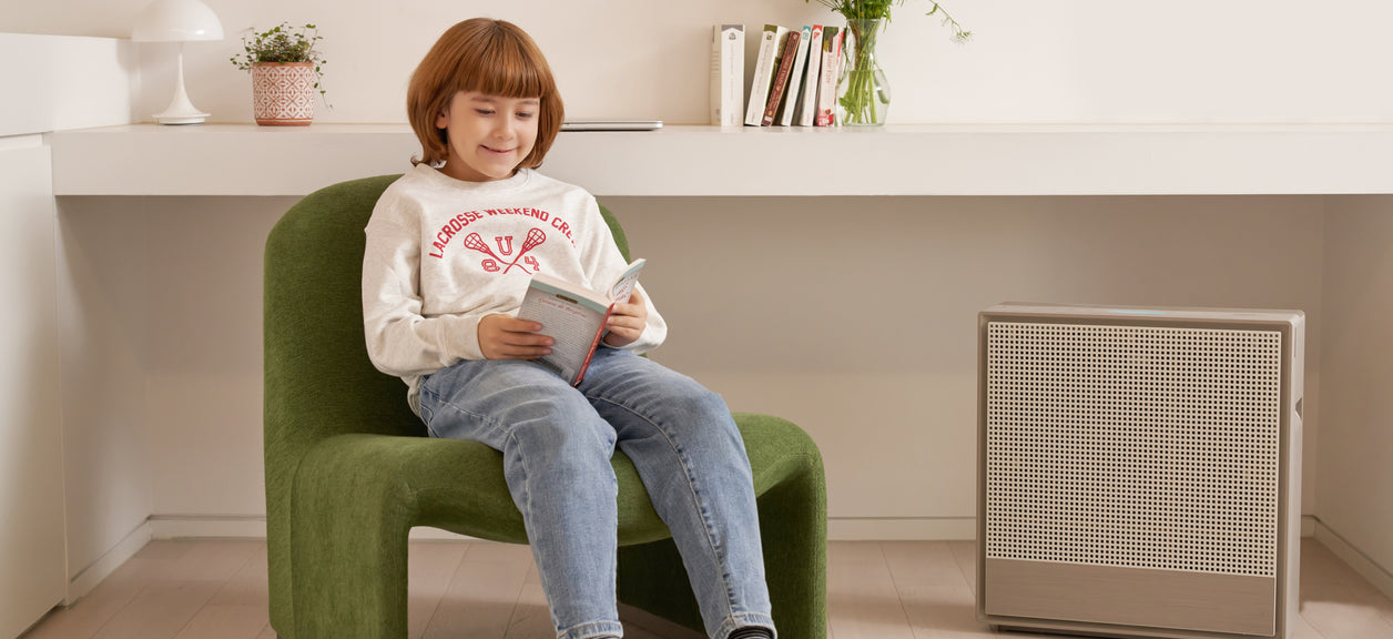 A student is happy to breathe clean air while reading.
