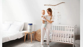 A mother and baby in a nursery with an Airmega 100.