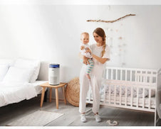 A mother and baby in a nursery with an Airmega 100.