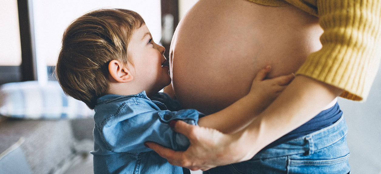 Child kissing mother's stomach_large